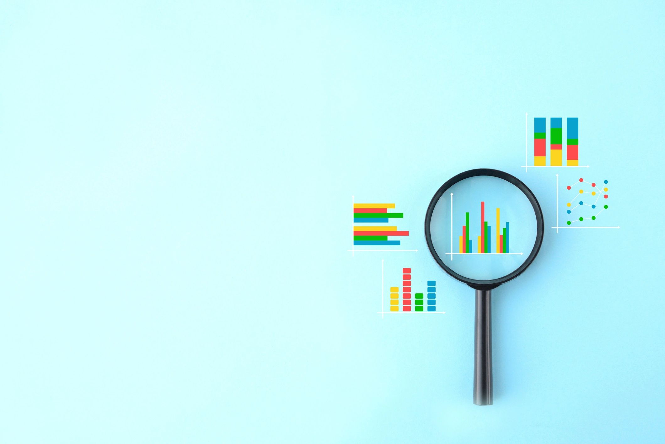 Business graphs with magnifying glass on blue background