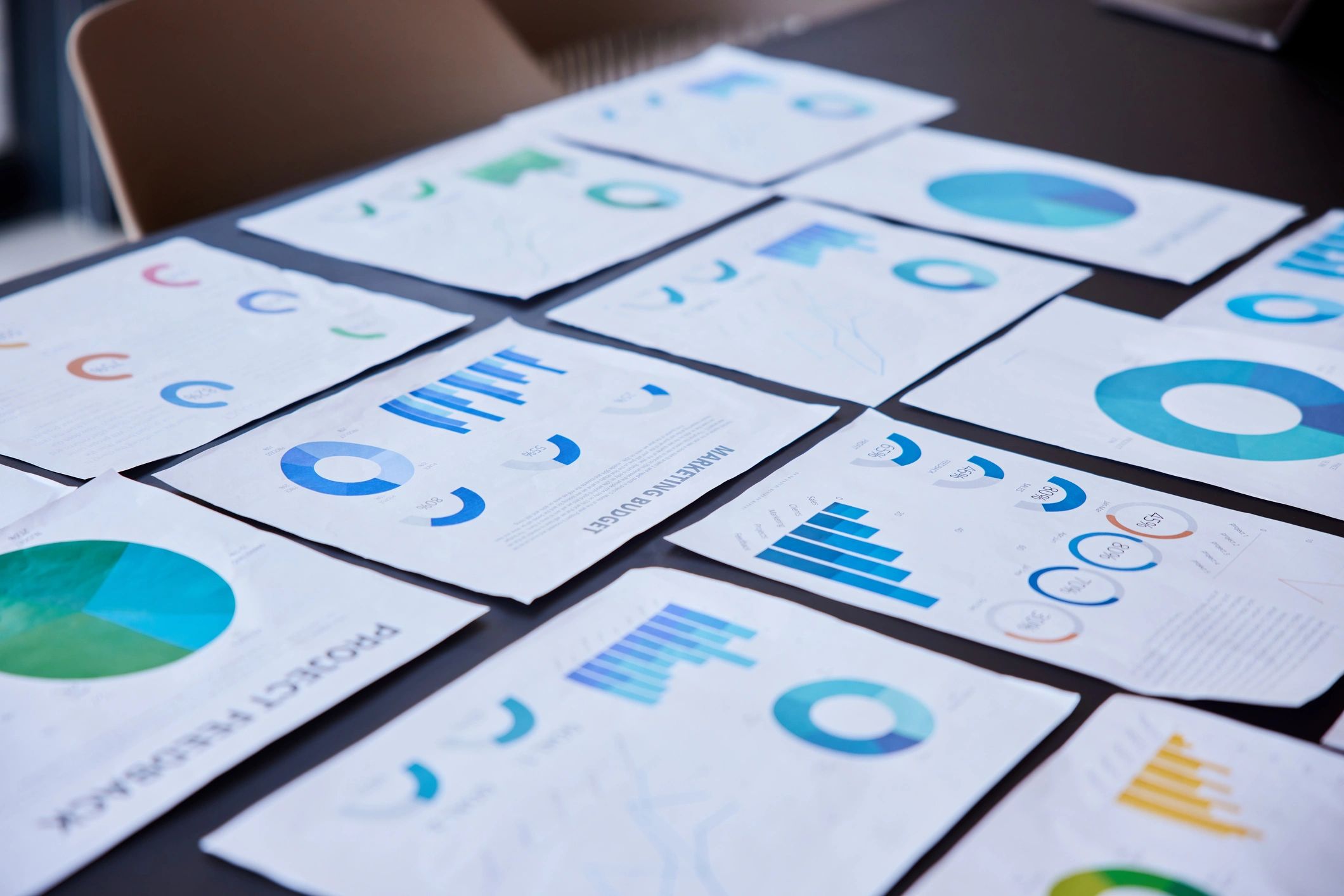 Analytical paperwork with charts on conference table